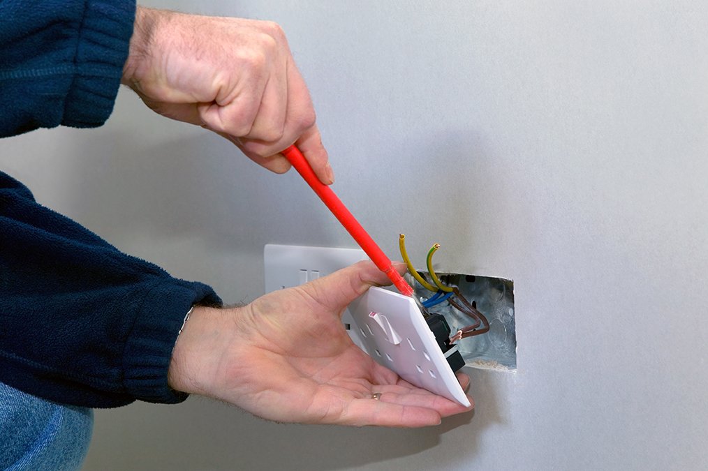 Electrician installing a socket